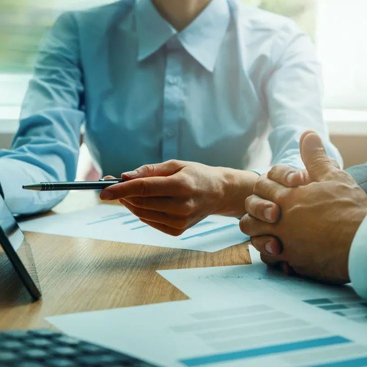 Hand writing notes on paper at a desk — public speaking preparation concept
