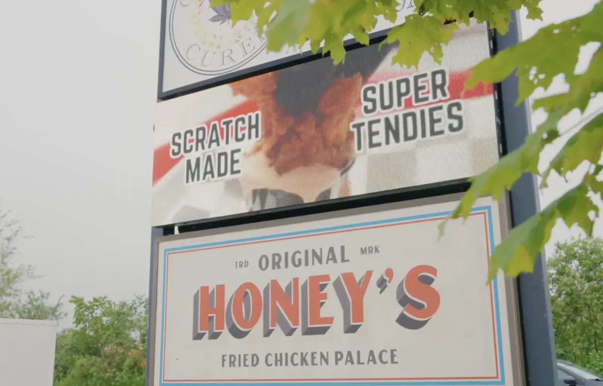 Restaurant interior with a NexaPanel X1 above the counter displaying specials.