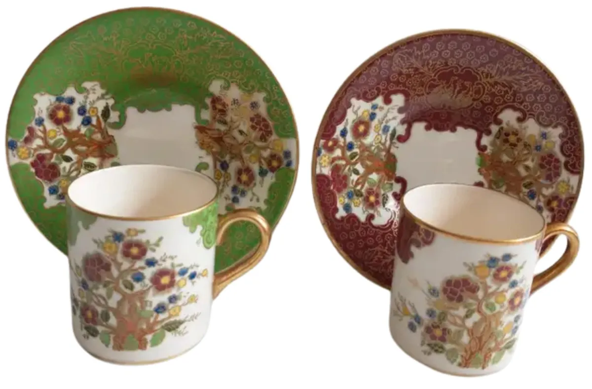 Soho Pottery Ambassador Ware demitasse cups and saucers, green and red with gold gilding and floral design.