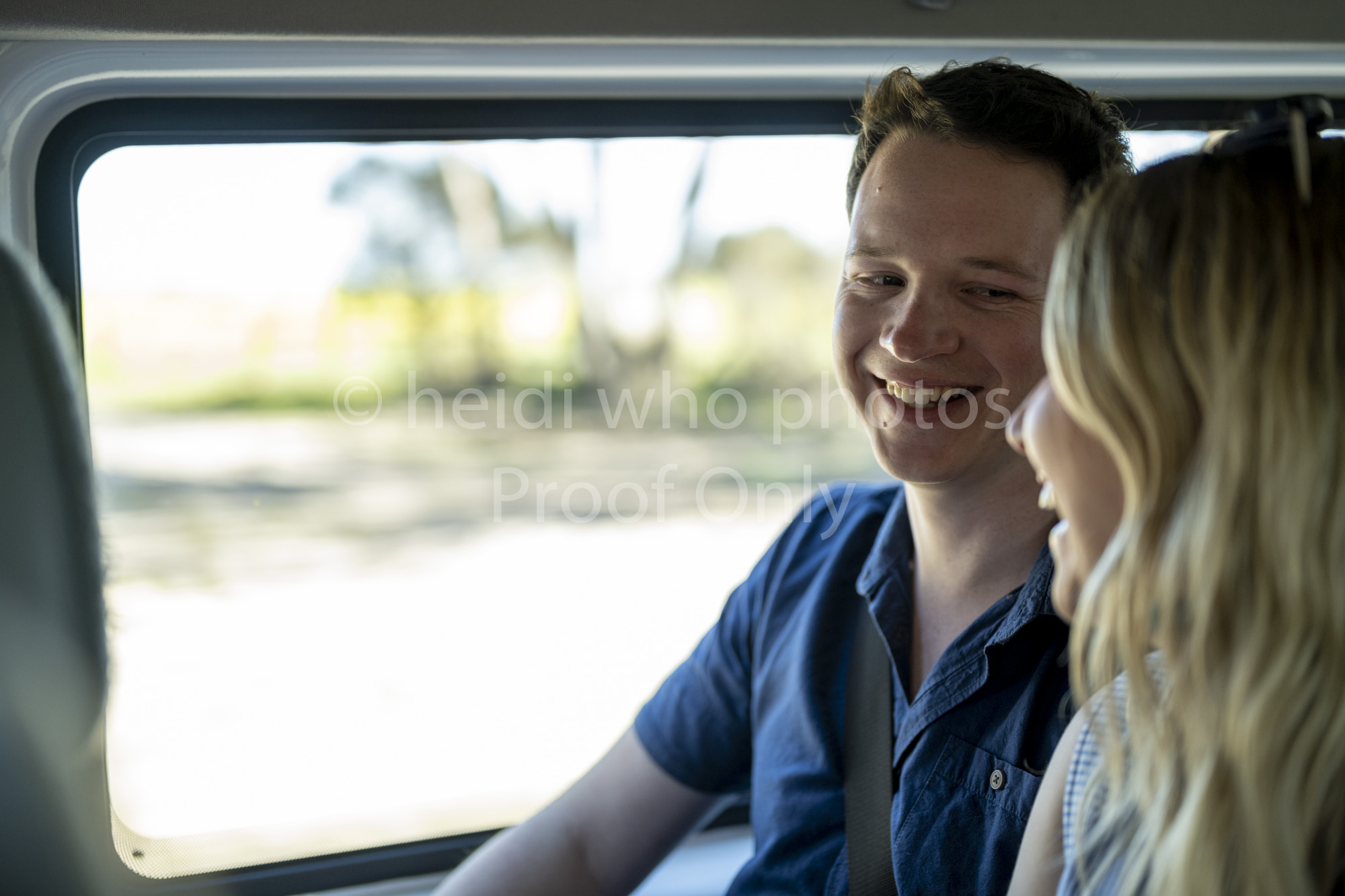 Local driver standing by a modern minibus on a scenic Kangaroo Island road