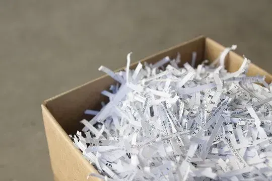 A box filled with shredded paper is sitting on a table.