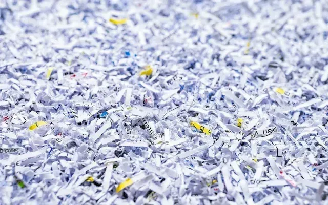A pile of shredded paper is sitting on a table.