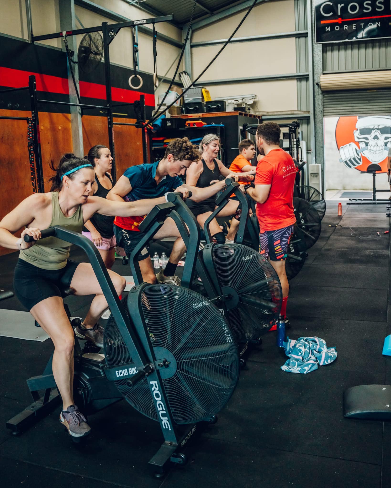 three person lifting barbels
