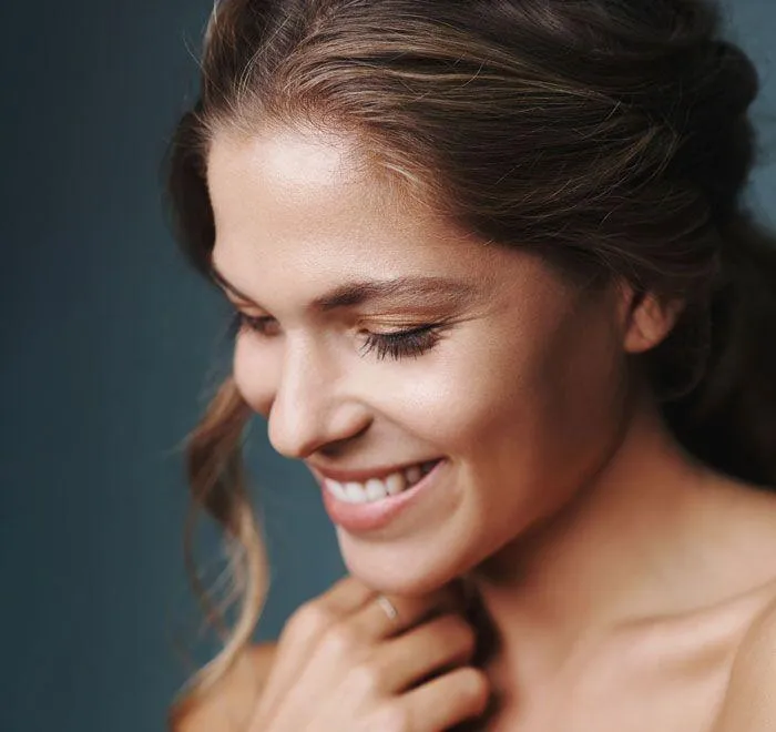 person holding clear glass bottle