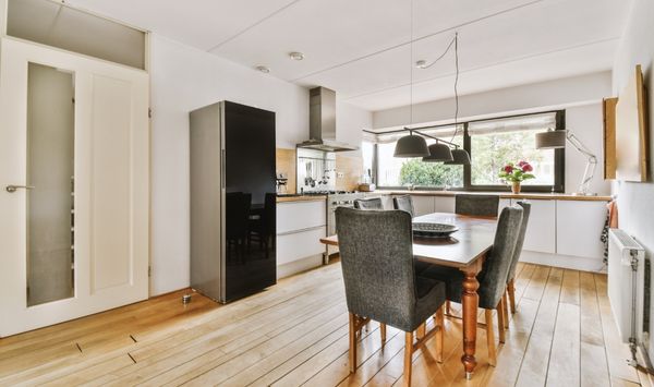 Open-concept tiny home kitchen and dining area with efficient layout and minimalist small space design