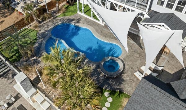 Backyard view of a residential property with pool, showing available outdoor space for a possible ADU or backyard living space in Bridgeport CT