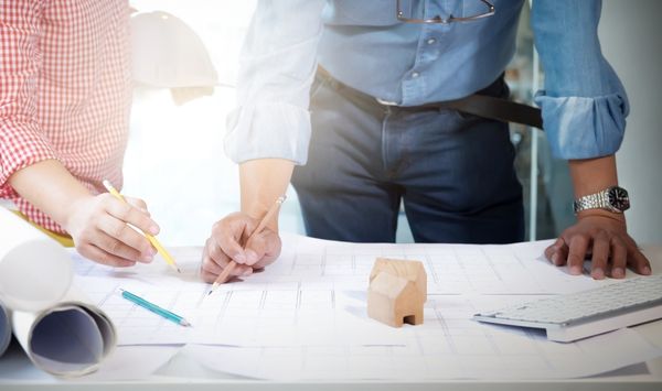 Connecticut ADU planning consultation with professionals reviewing property blueprints and home layout options