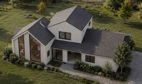 Aerial view of a contemporary white home with multiple gable roofs, large windows, and landscaped grounds, illustrating custom ADU design inspiration for Connecticut homeowners.