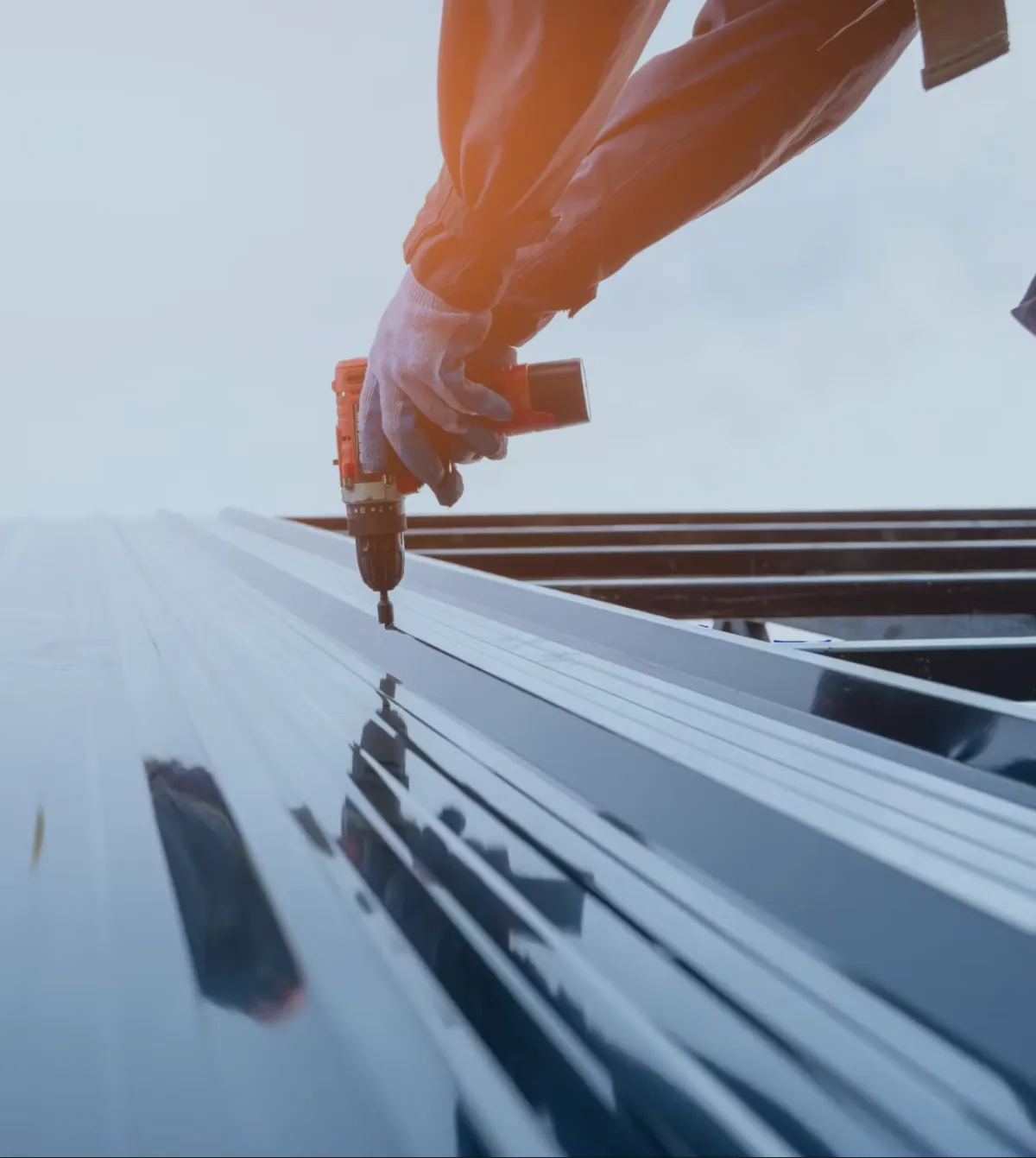 706-Pro-Roof technician installing metal panels on a commercial or residential roof in Northeast Georgia