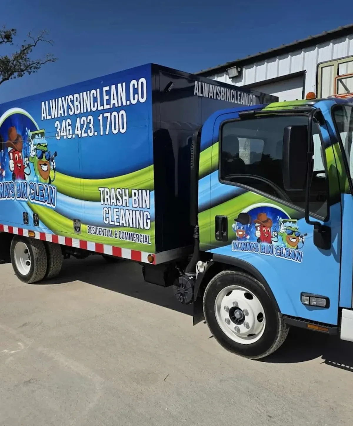A blue and green 'Always Bin Clean' trash bin cleaning service truck with company logo and contact info on a sunny day.