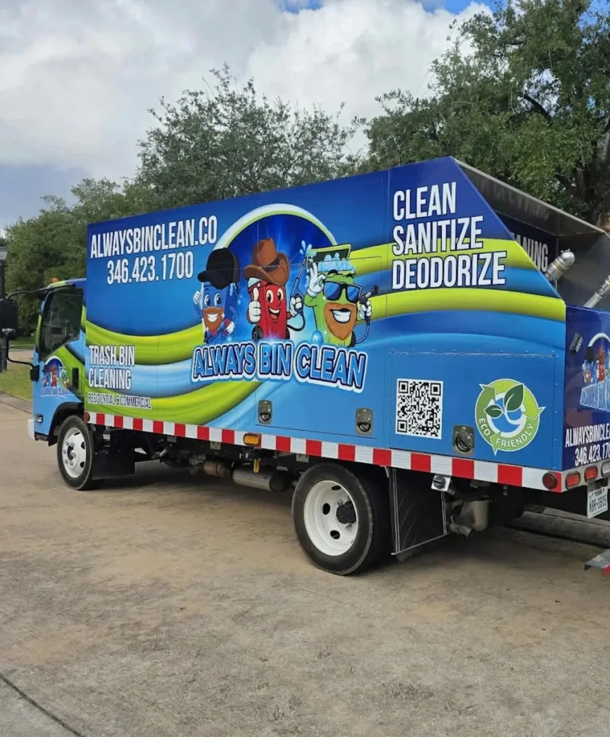 A vibrant blue trash bin cleaning truck with cartoon mascots and 'Always Bin Clean' branding parked on pavement.