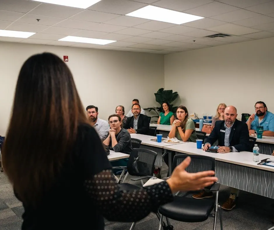 Tanya Seabrook speaking at a professional networking luncheon, helping local businesses, nonprofits, and service providers grow through marketing strategies.