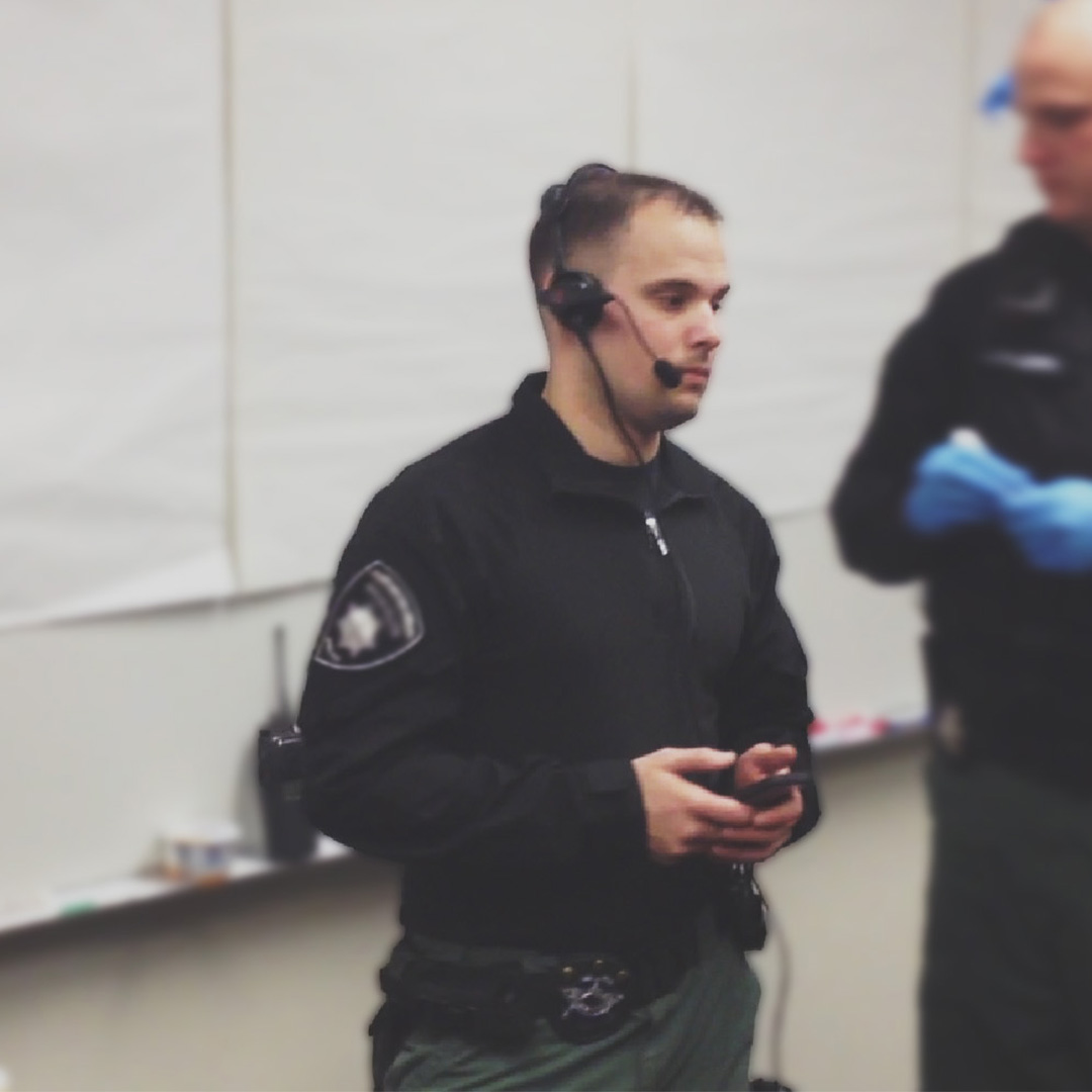 police hostage negotiator talking wearing a headset