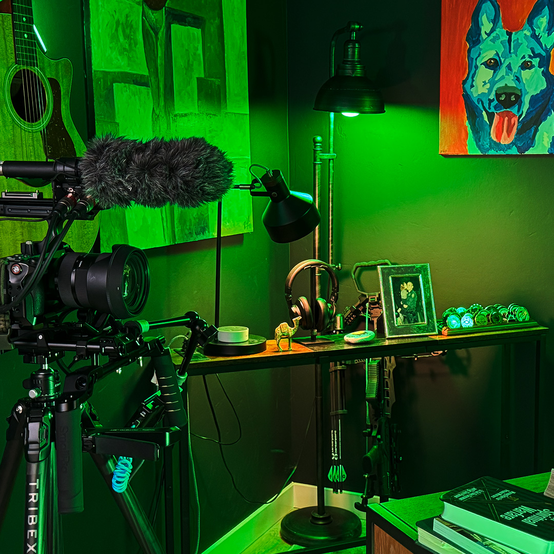 Office studio with green lighting a black camera