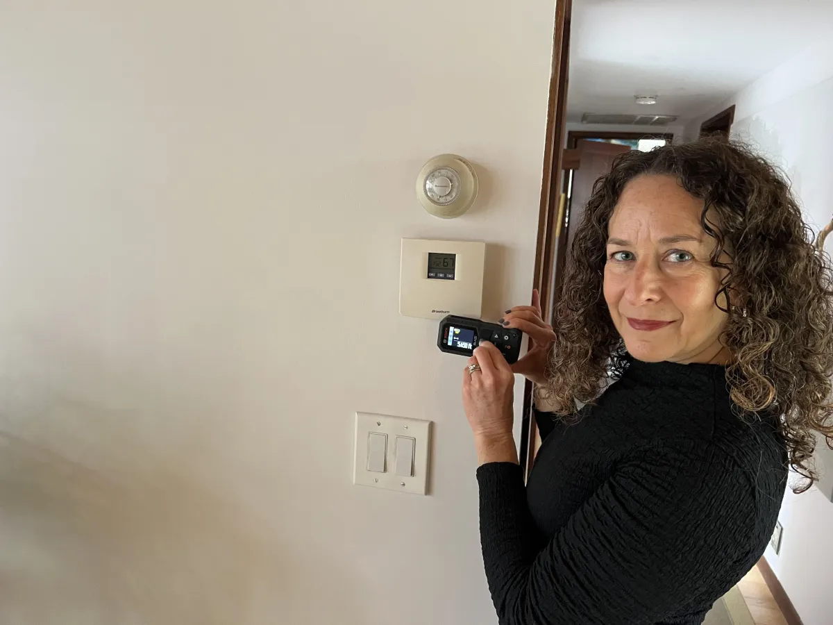 Jodi measuring a floor plan for real estate listing