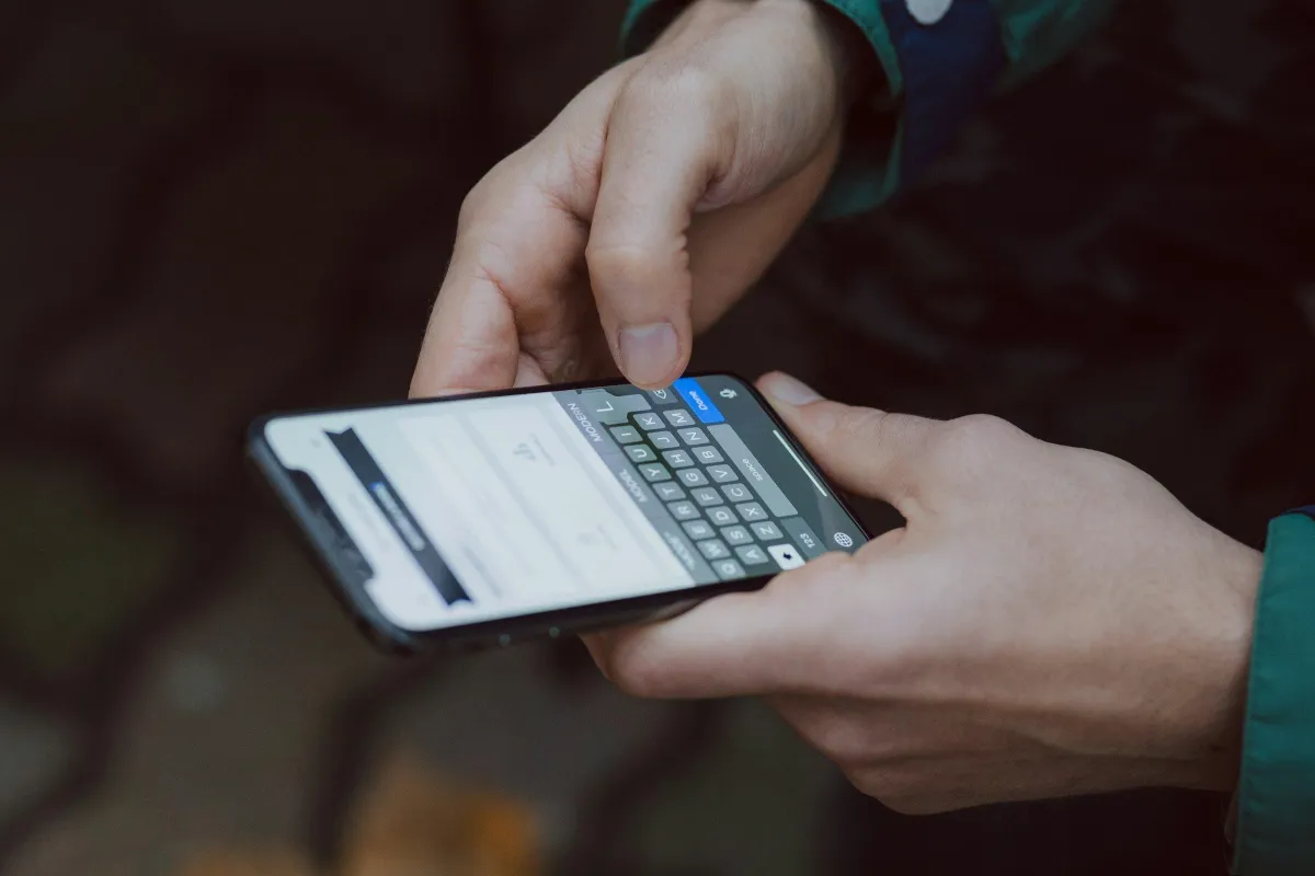 Hands texting on iPhone — fast and easy mobile quote request for selling your used phone for cash in DFW or Los Angeles