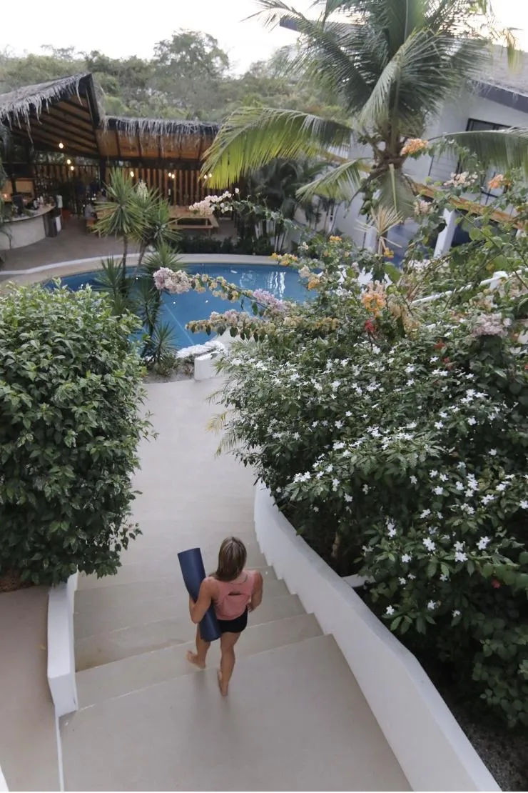 Serene corner of Casas Kismet property showing lush tropical landscaping and stone pathways
