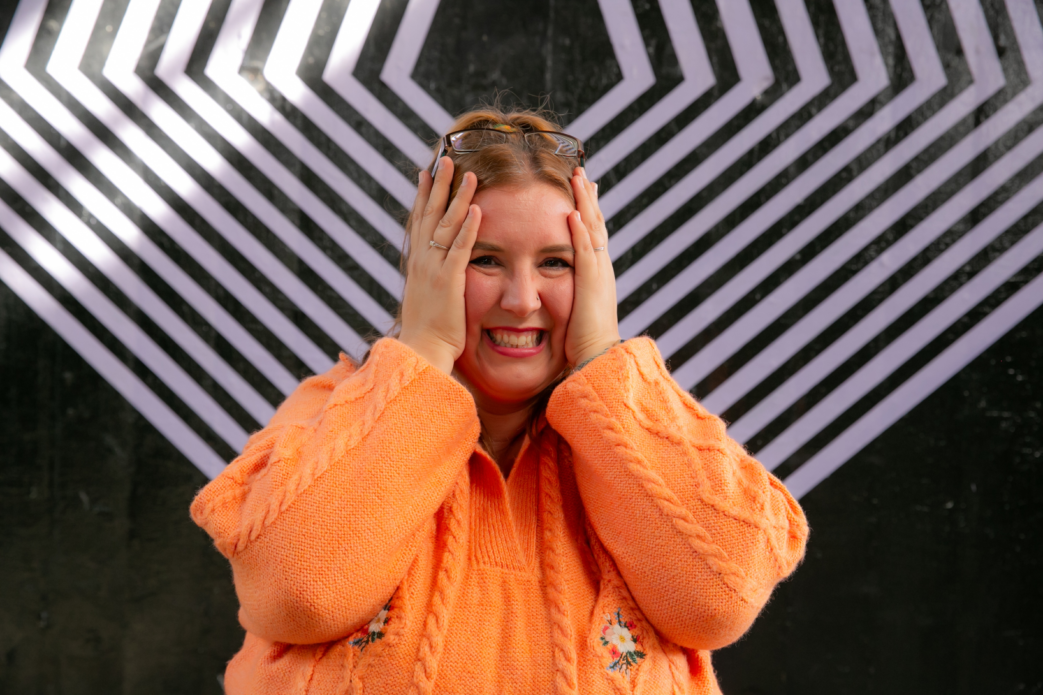 Rachel Clayton playfully holds a rainbow pen in front of her face while looking surprised. The image accompanies a personal reflection explaining that many neurodivergent people don't recognise burnout until they're already experiencing it deeply.
