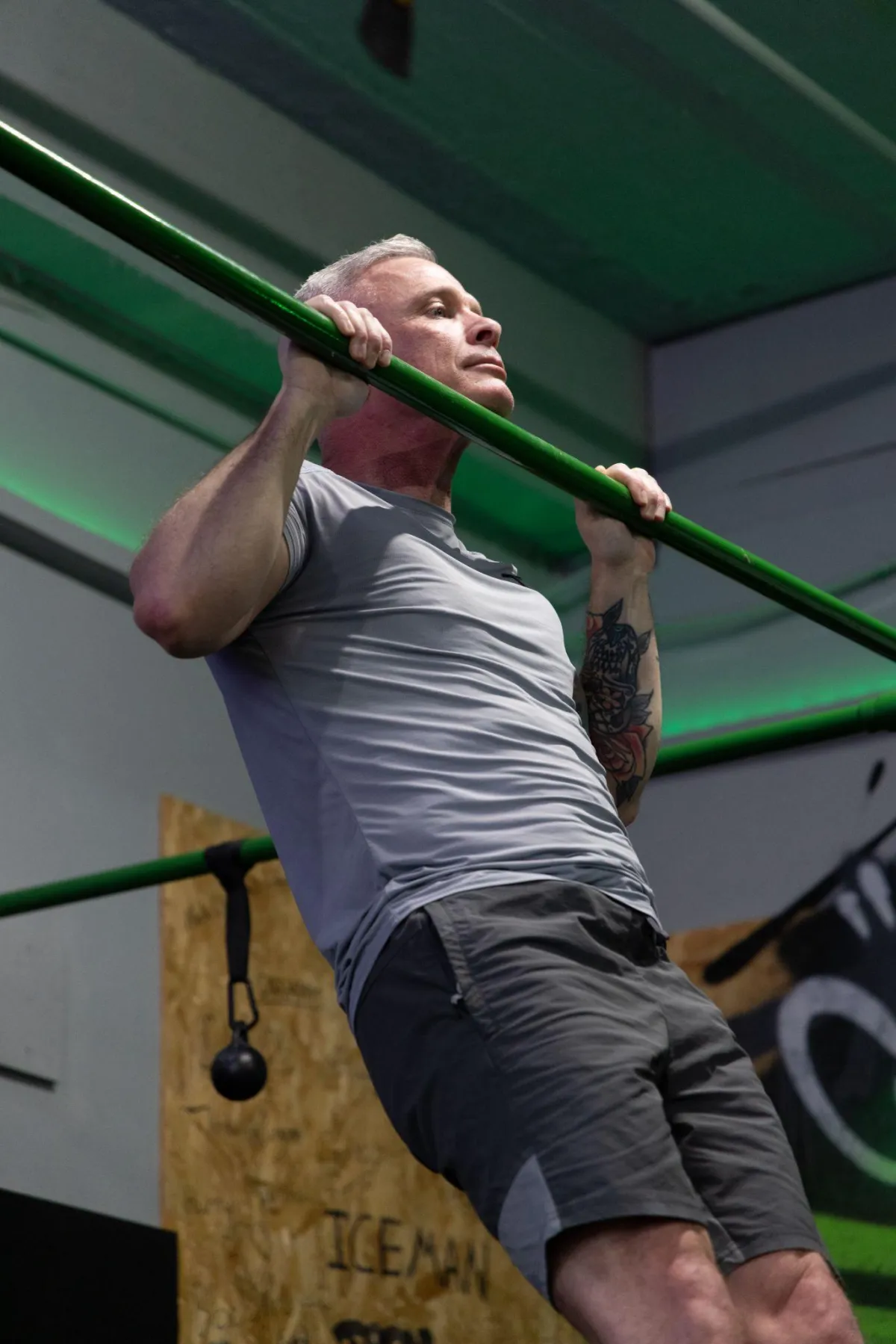 Athlete performing advanced calisthenics movement on bars
