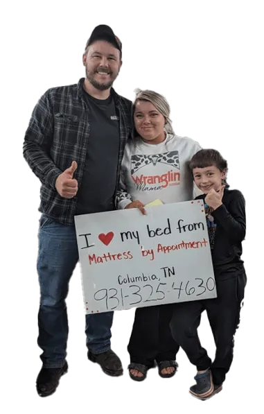 A picture of a happy family that bought a mattress holding an "I love my new mattress" sign