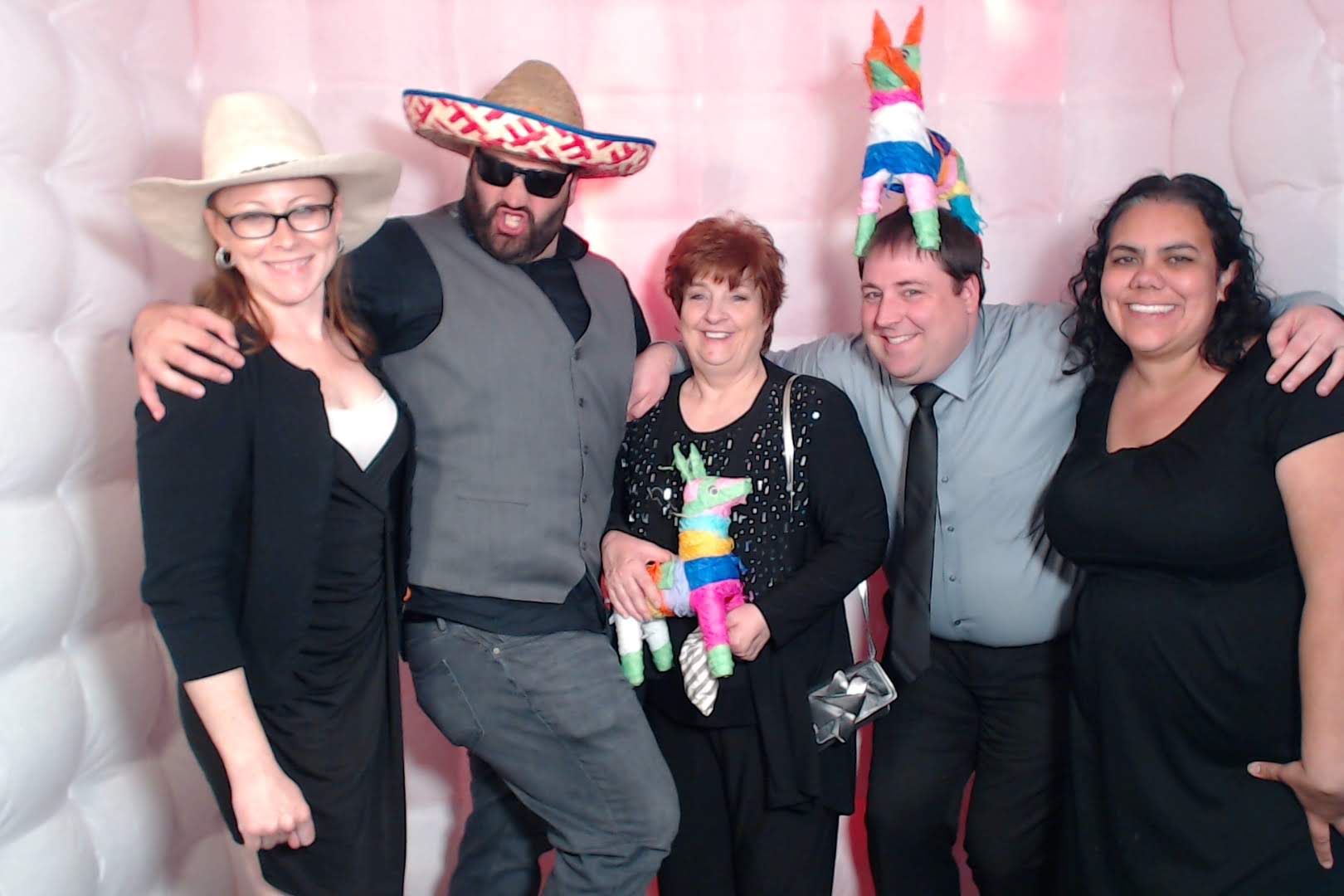 Guests having fun with props at interactive photo booth rental