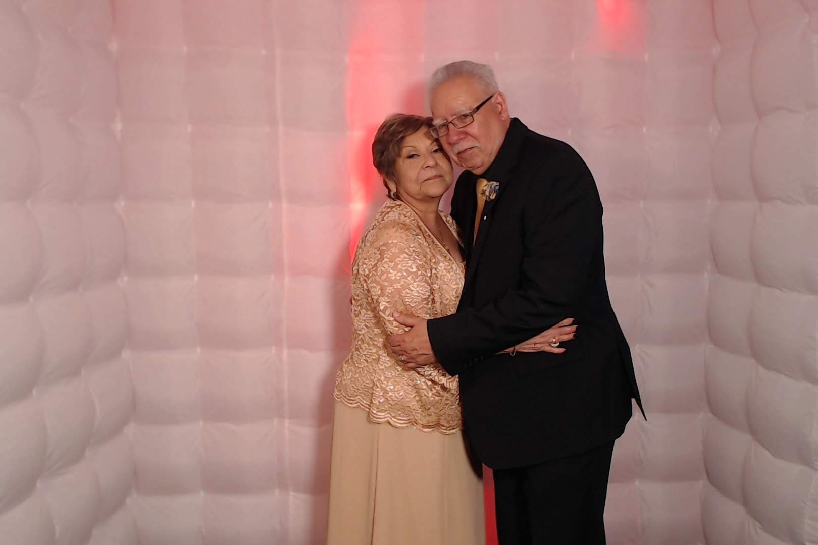 Orange County wedding couple posing together at elegant reception photo booth