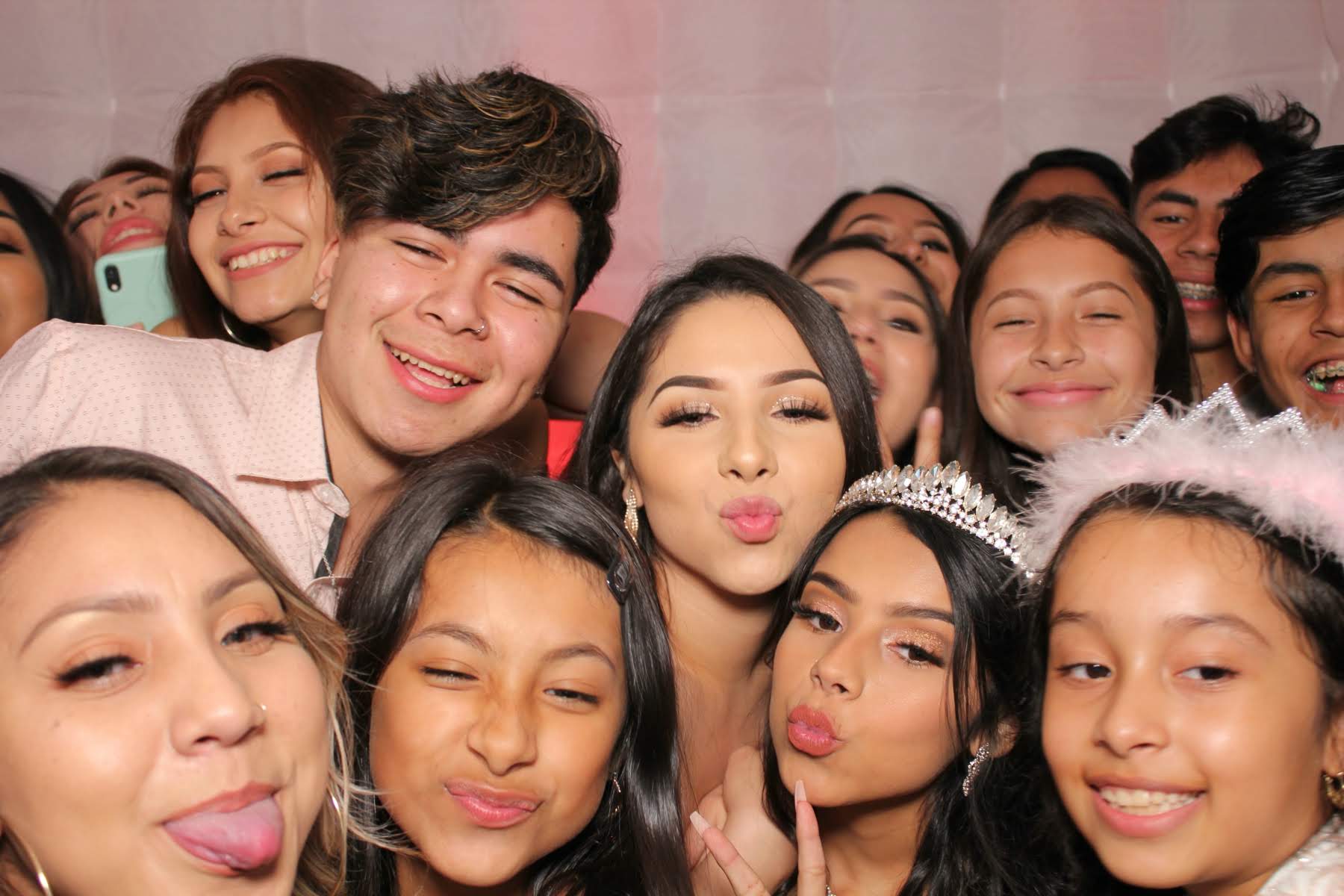 Orange County quinceañera guests taking fun group photo booth pictures