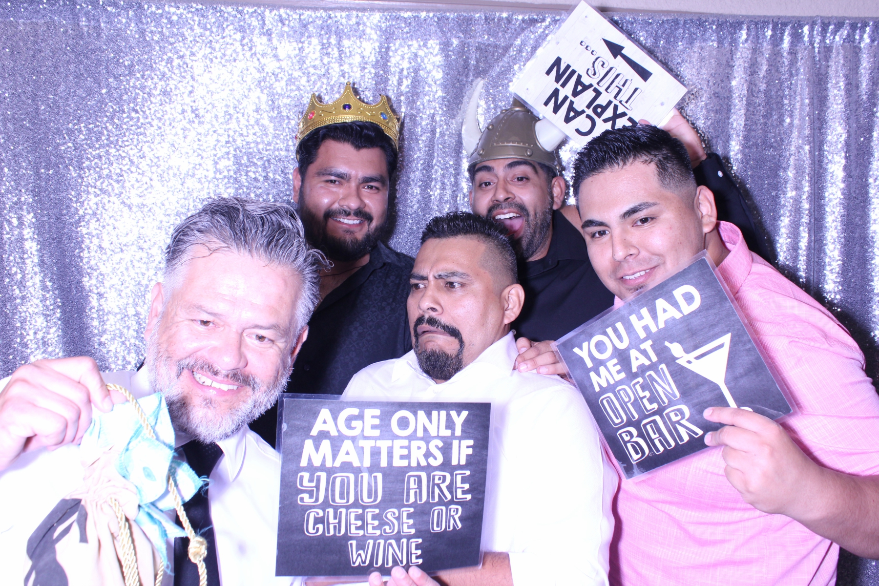 Guests posing with funny signs at event photo booth rental