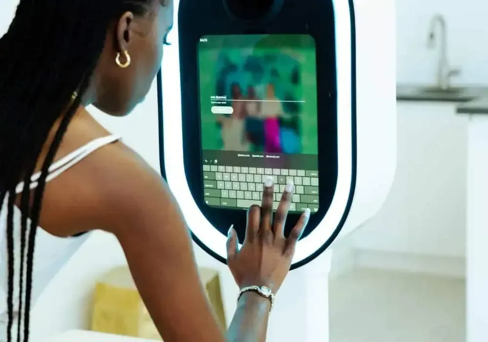 A woman explores a photo gallery on a touch screen device, using her index finger to navigate through the illuminated display.