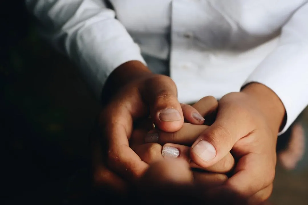 Hands gently holding, symbolizing care and support.