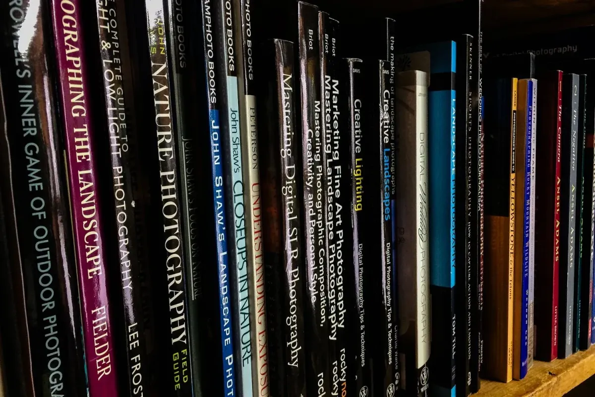 A number of photography books on the book shelf creating a great reading list