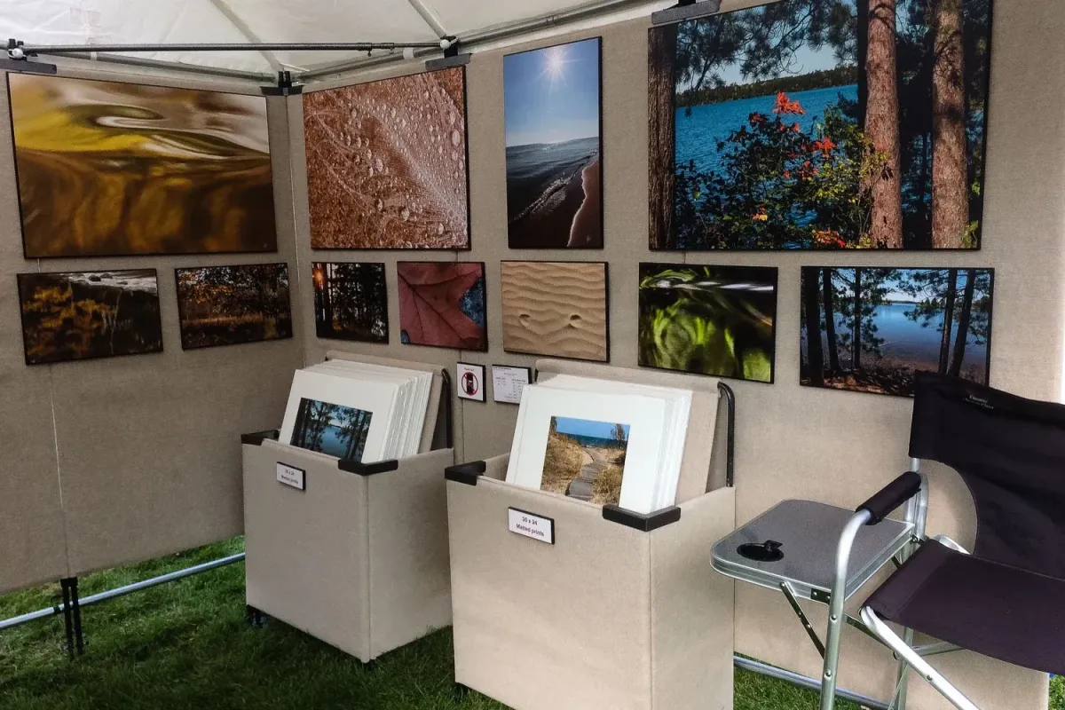 Art fair booth looking at print flip bins