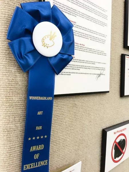 A blue ribbon award from an art show