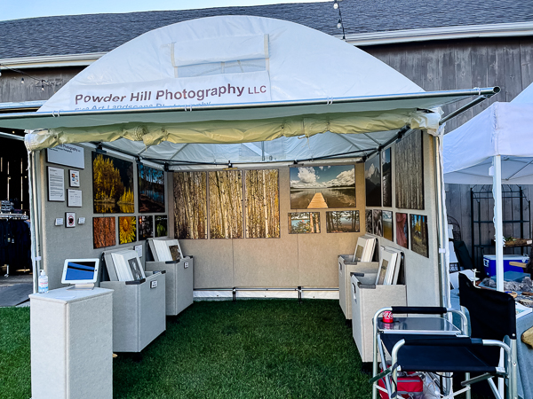 Art fair booth set up for the show, with the chair in the front right
