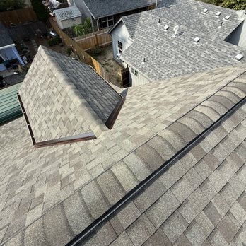 The roof of a building with a tree in the background