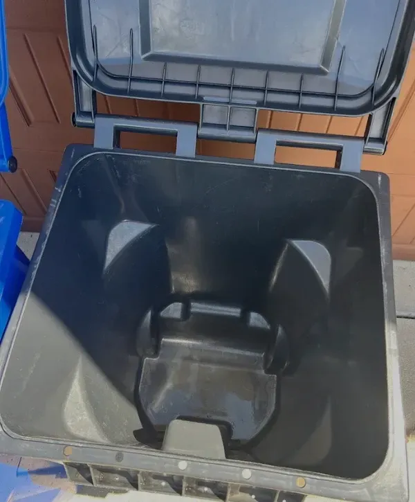 Inside view of a freshly cleaned black trash bin