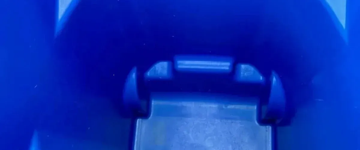 Clean and empty blue trash bin interior after professional washing.”