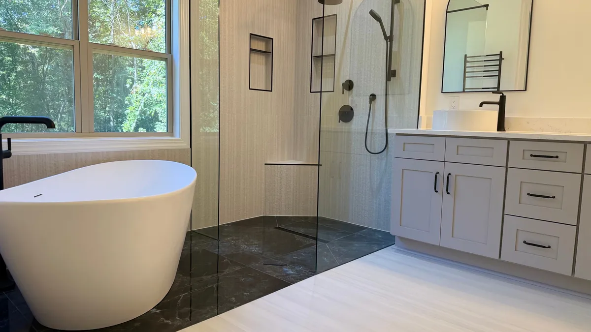 JR Remodeling bathroom with freestanding tub, glass shower and vanity
