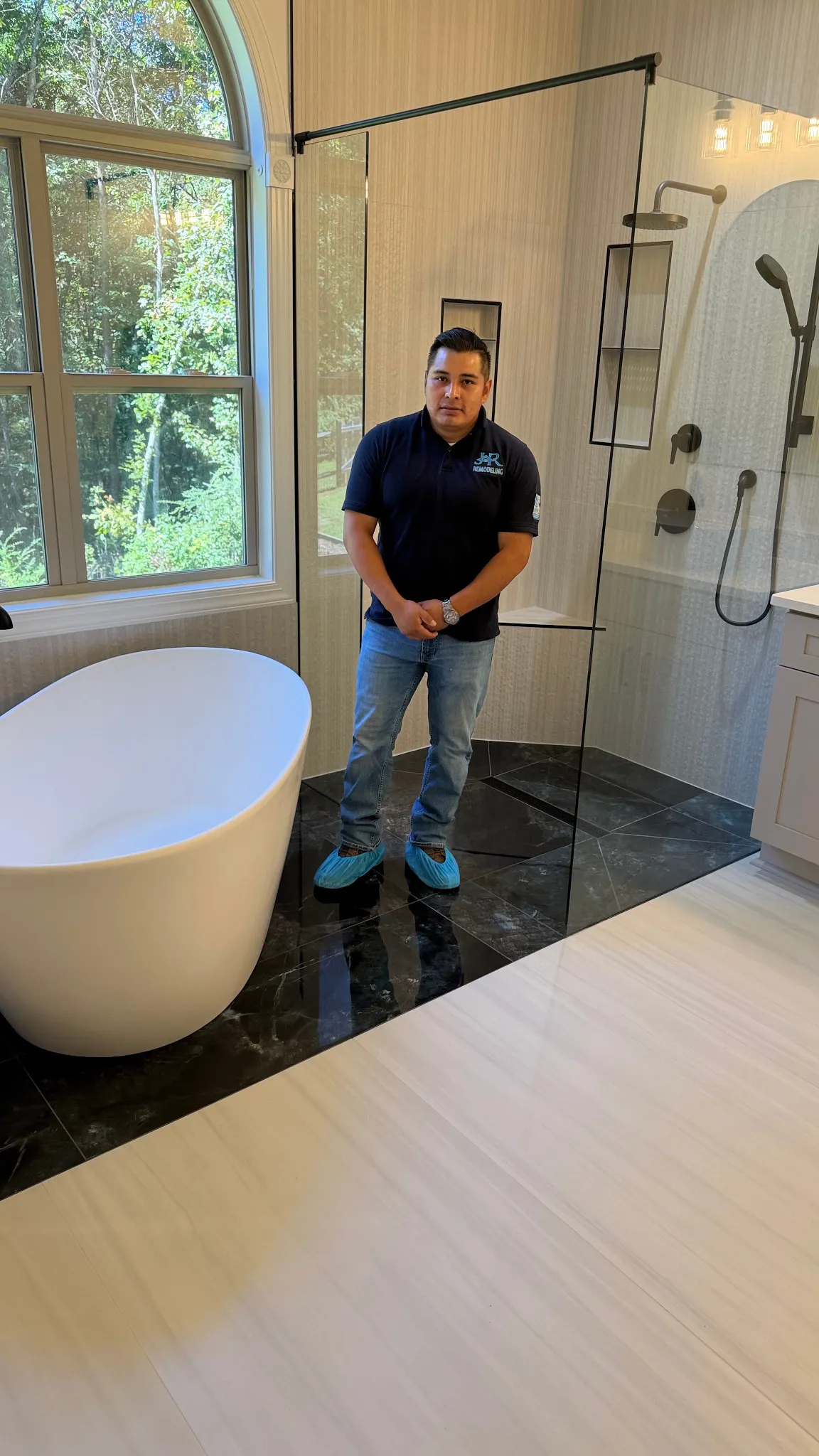 Carlos Rodriguez of JR Remodeling in a completed bathroom