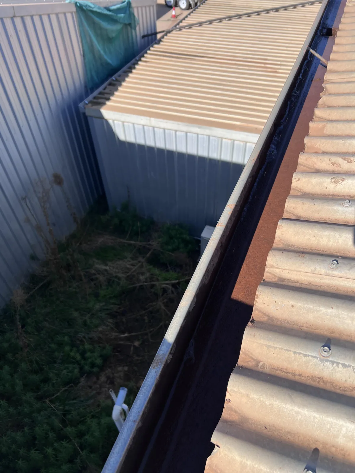 Clean and clear corrugated roof gutter after full debris and grass removal, showing restored water flow following expert gutter cleaning in Mildura.