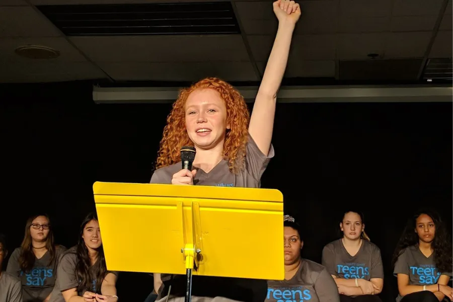 Teen holding fist up at TWTS event