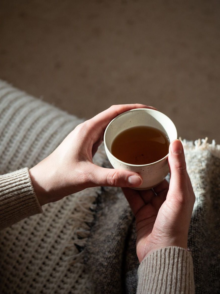 hands holding coffee cup