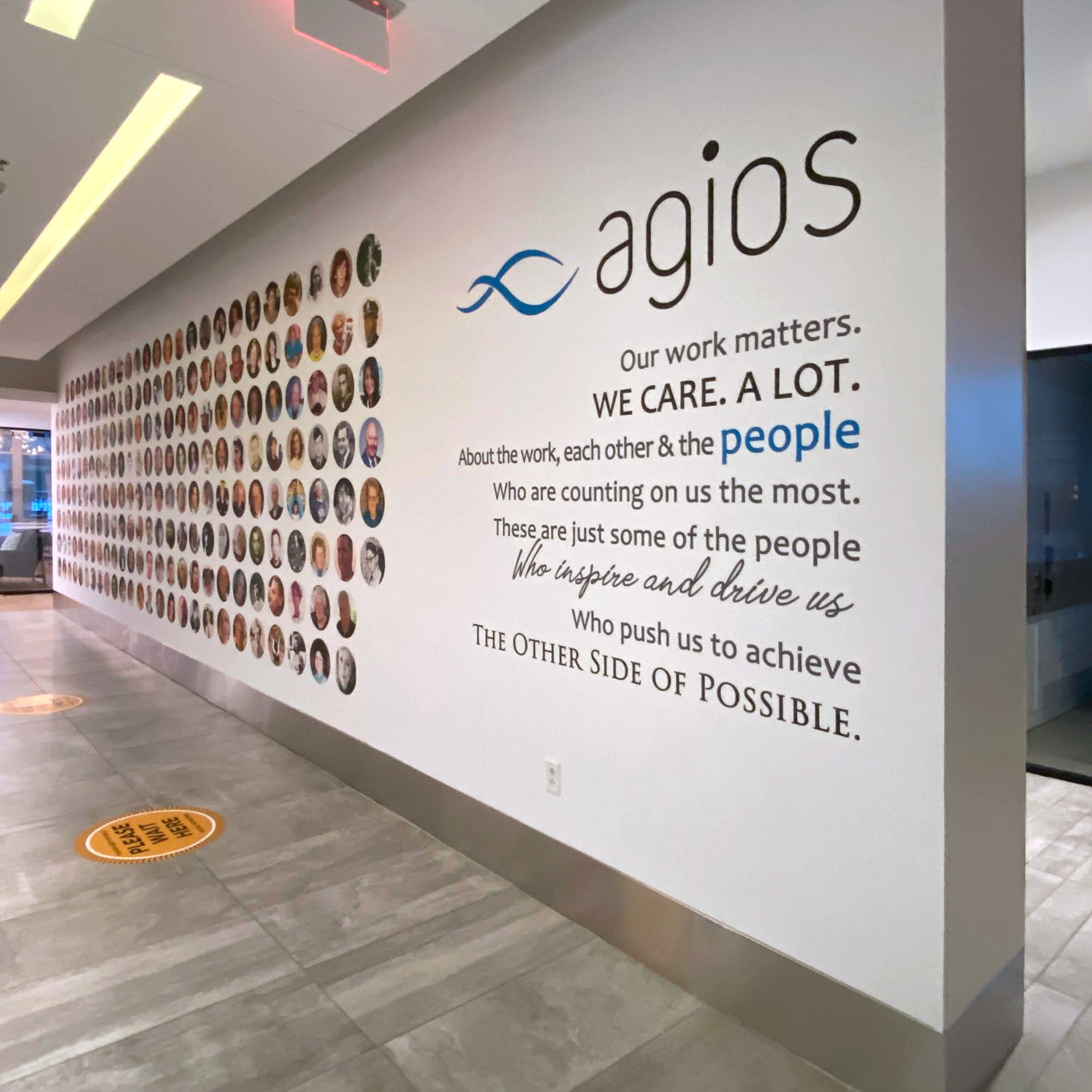 Custom branded office wall mural and environmental graphics installation inside commercial workspace