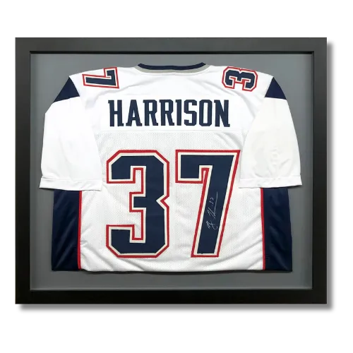 Custom framed football jersey display with shadow box presentation and professional sports memorabilia framing