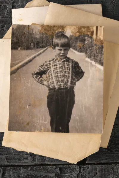 an old photography of a boy that needs restoration, as a visual example of photo scanning services in Boston, for The Beacon Studio