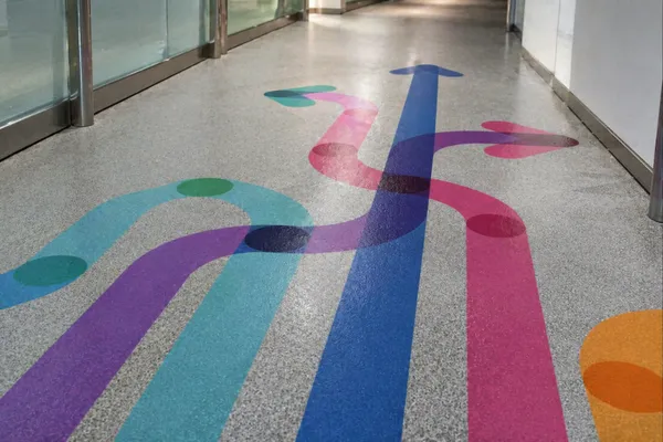 Durable floor graphics with directional design installed in commercial space
