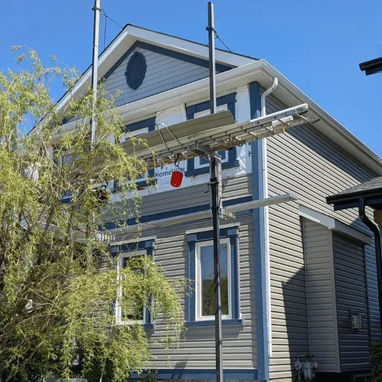 Calgary roofing company repairing damaged roof shingles