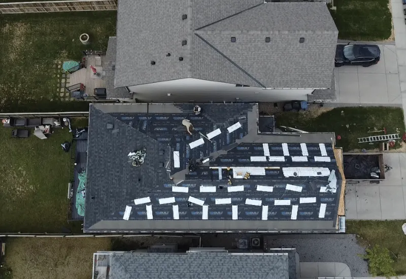 Shingle roof and gutters showing potential storm damage in Calgary.