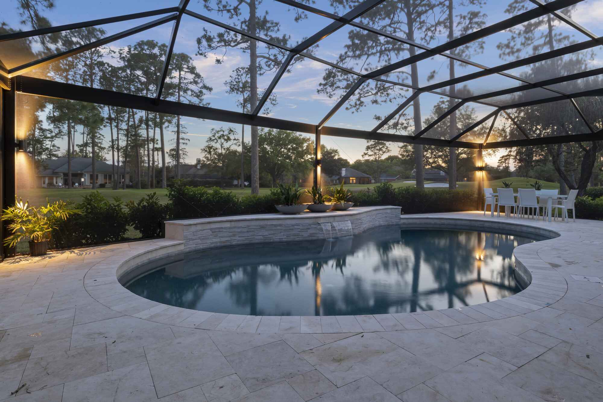 High-resolution residential photograph featuring architectural lines of a pool enclosure by Impact Enclosures in Jacksonville Florida