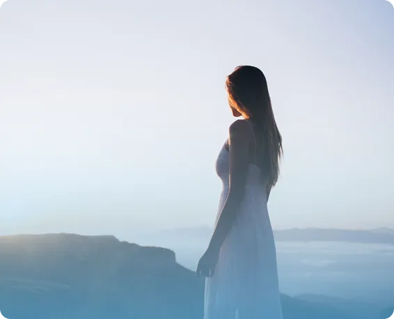 Person meditating on a beach at sunset with eyes closed—mindfulness, calm breathing, relaxation, and mental wellness.